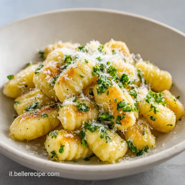 Perfectly arranged gnocchi, glistening with sauce, artfully plated with a sprinkle of parmesan and a sprig of fresh rosemary.